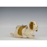 A rare British lying dog purse, 1930s, with white and brown mohair, orange and black glass eyes,