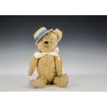 A French teddy bear 1930s, with golden mohair, clear, black, green and white elliptical,