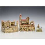 Two German paper on wood toy castles, largest - 11in. (28cm.) high; a tiny wooden castle with ink