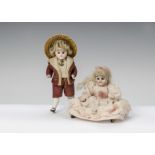 Two German all-bisque dolls’ house doll children: a boy with fixed dark eyes, blonde wig, painted