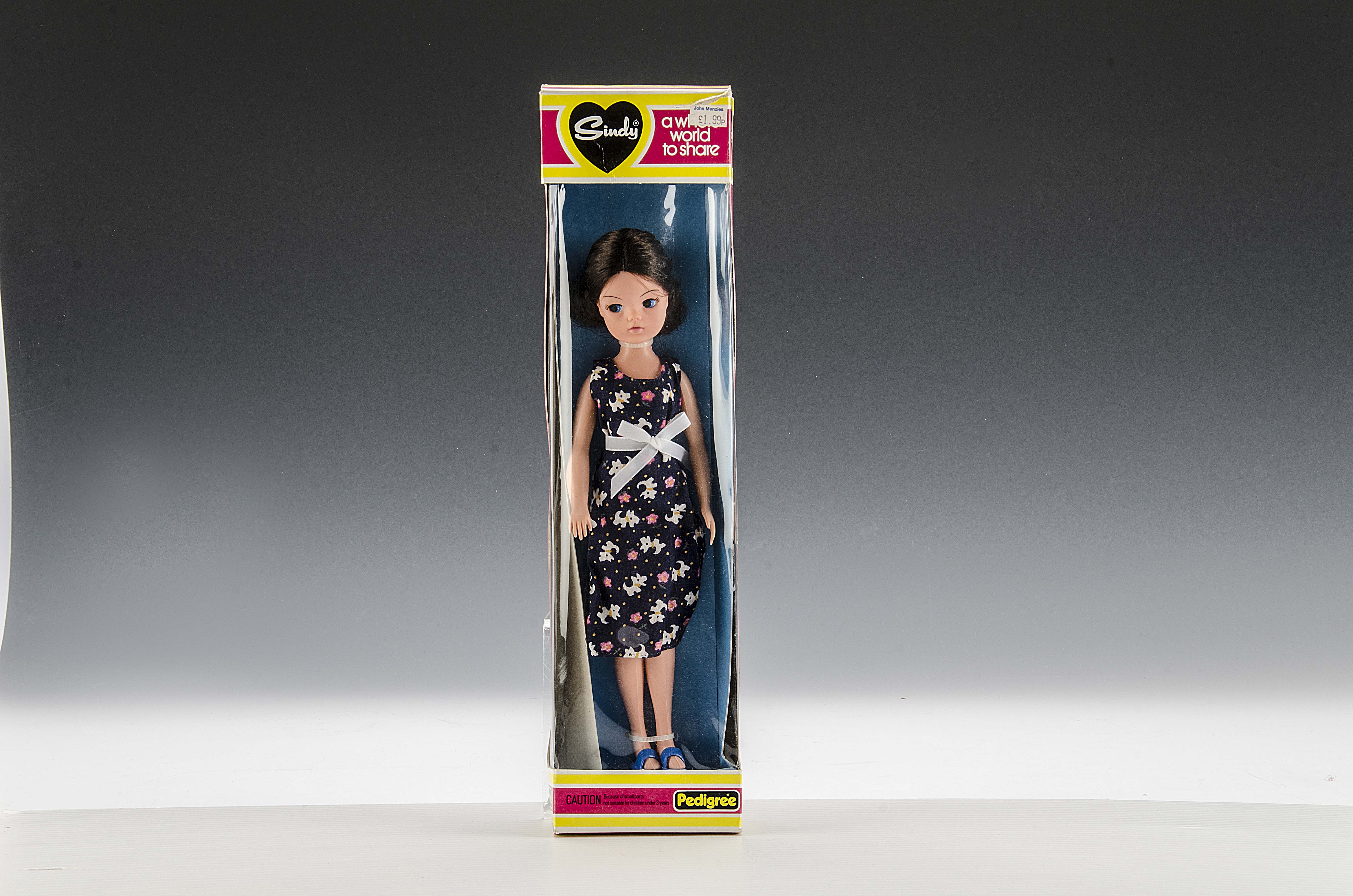 A Pedigree Sindy for John Menzies, 1981, brunette doll in dark blue dog print dress, in original