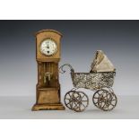 A doll size long case clock, with enamel dial, Art Noveau carved detail and sun pendulum - 101?