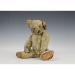 A J.K. Farnell teddy bear, circa 1920, with blond mohair, pronounced clipped muzzle, remains of