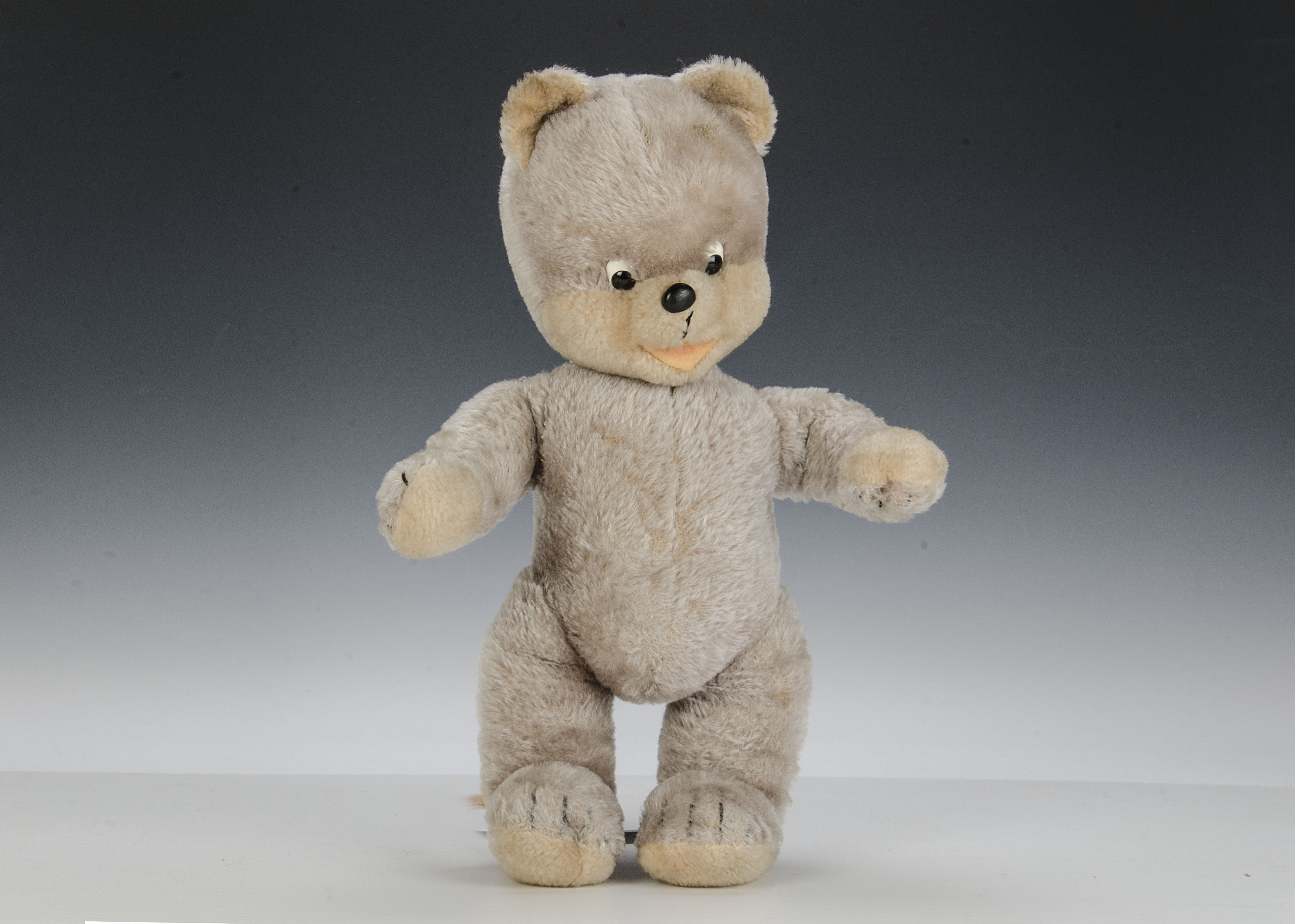 A Schuco talking bigo-belo teddy bear 1950s, with beige mohair, black and white plastic googlie