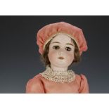 A William Goebel child doll, with brown lashed sleeping eyes, brown mohair wig, jointed