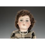 An Armand Marseille 390 child doll, with blue lashed sleeping eyes, brown mohair wig, jointed