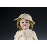 A Simon & Halbig 1349 Jutta child doll, with blue sleeping eyes, pierced ears, brown mohair wig,