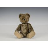 A Schuco Tricky yes/no teddy bear 1950s, with beige mohair, clear and black glass eyes with brown