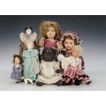 Various dolls: a composition black baby doll with broad nose and afro moulded hair - 111?2in. (