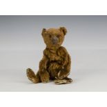 A small early Steiff Teddy Bear circa 1908, with dark cinnamon mohair, black boot button eyes,