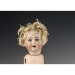 A Schutzmeister & Quendt 201 character baby, with blue sleeping eyes, blonde mohair wig and