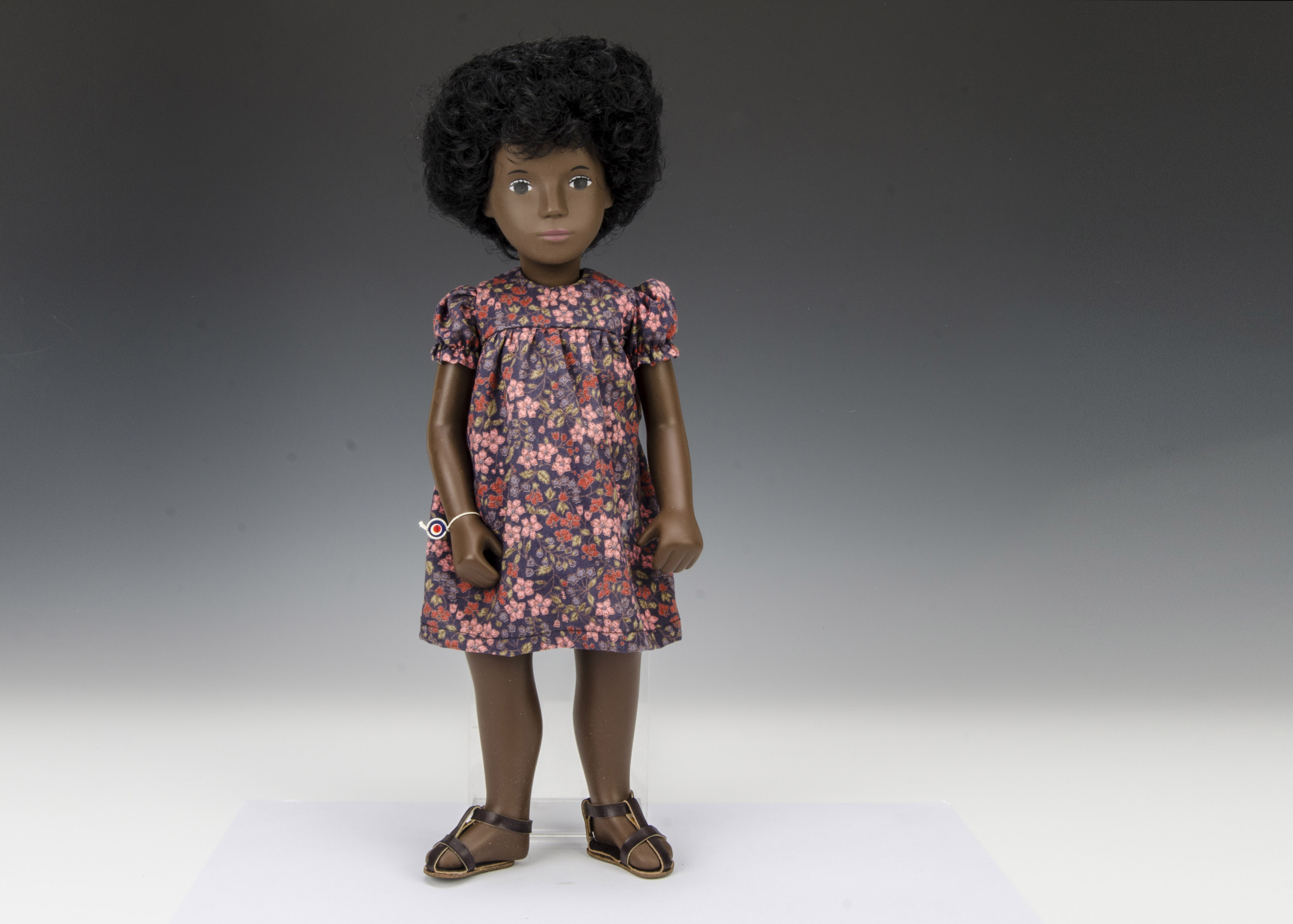 A Trendon Sasha doll Cora Flower Dress, 118, with black curly hair, floral print dress, sandals