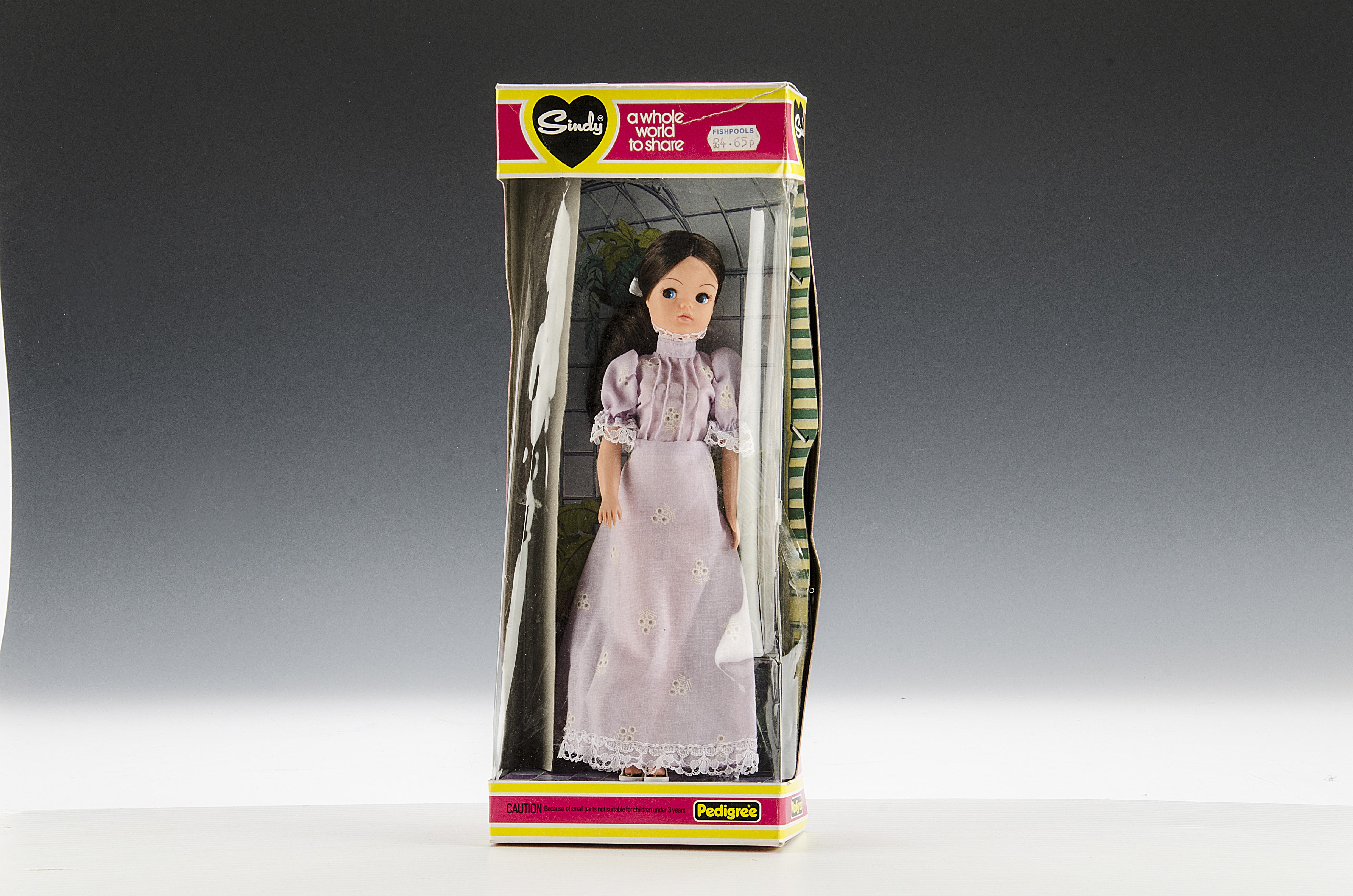 A Pedigree Styling Sindy, 1982, with long brunette hair and mauve high neck dress, in original