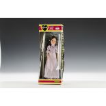 A Pedigree Styling Sindy, 1982, with long brunette hair and mauve high neck dress, in original