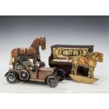 A German painted carved wooden cart horse on wheels, on green base - 91?2in. (24cm.) long; a Gibbs