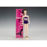An Ideal Mitzi doll, with brunette hair, pearl earrings, purple two-piece costume and black shoes,