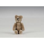 A Schuco miniature Janus teddy bear 1950s, with beige mohair, two faced with metal features, one