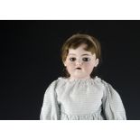 A Simon & Halbig 1080 DEP shoulder-head dolls, with head turned slightly to the right, brown