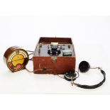 Crystal set: a home-made crystal set in leatherette covered case, with headphones; and a tinplate