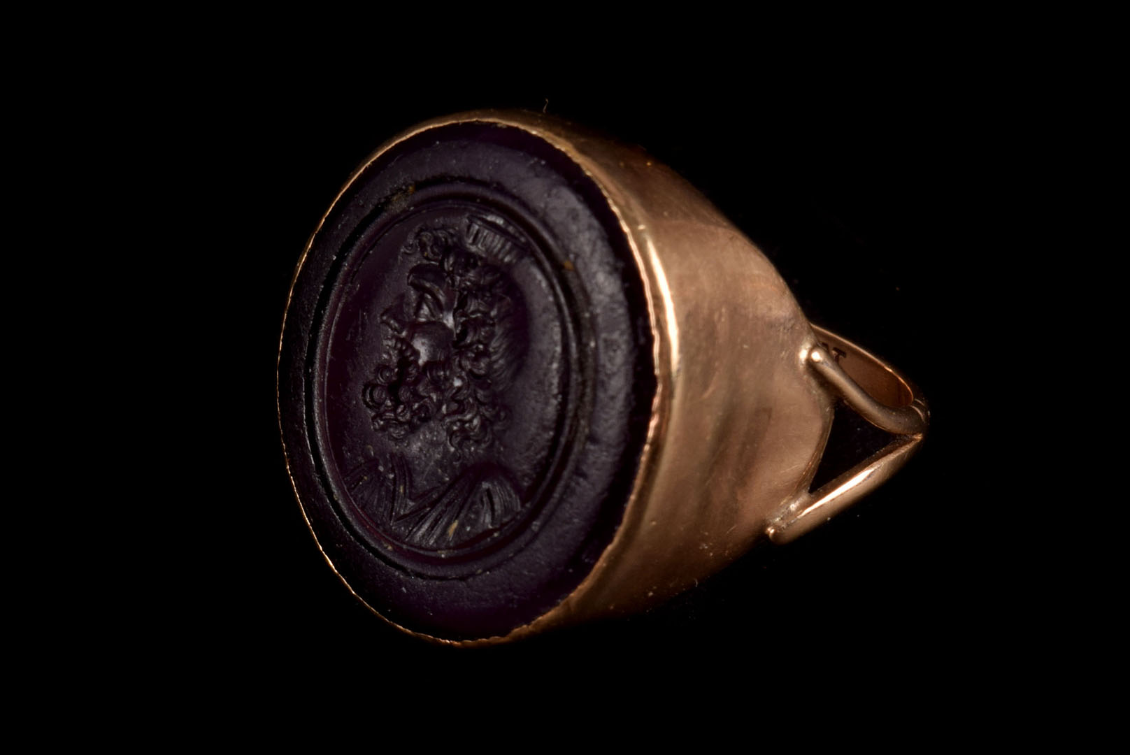 A 19th century mauve stone signet ring, the large mauve coloured stone with male silhouette