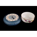 A small collection of matt glazed Devon pottery, including a wall clock, plates and a vase, and