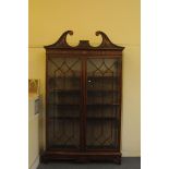 A fine 19th century mahogany and satinwood bookcase, having broken pediment above two astral