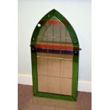 An Art Deco arched glass mirror, having green bevelled glass frame with multiple bevelled glass