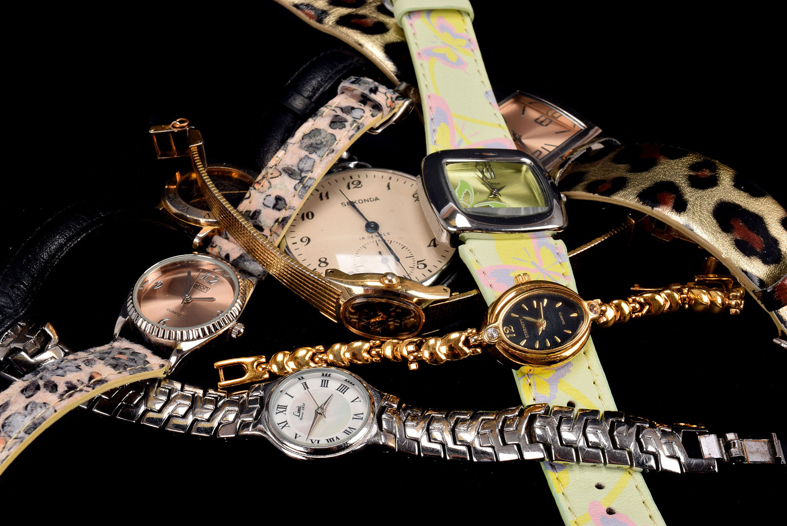 A small assortment of ladies wrist watches, including a yellow metal Seiko, a white metal Limit,