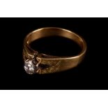 A gold and diamond ring, the circular cut stone in high white metal mount, seton a wide gold band,