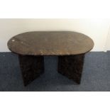 A 1970s Morrocan hardstone coffee table, with oval shaped top having fossil inclusions supported