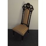 A late 19th century French walnut Prie Dieu chair, having carved and pierced back splat with