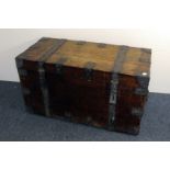 A vintage wooden travel chest, rectangular form with hinged lid and cast iron strapwork, AF