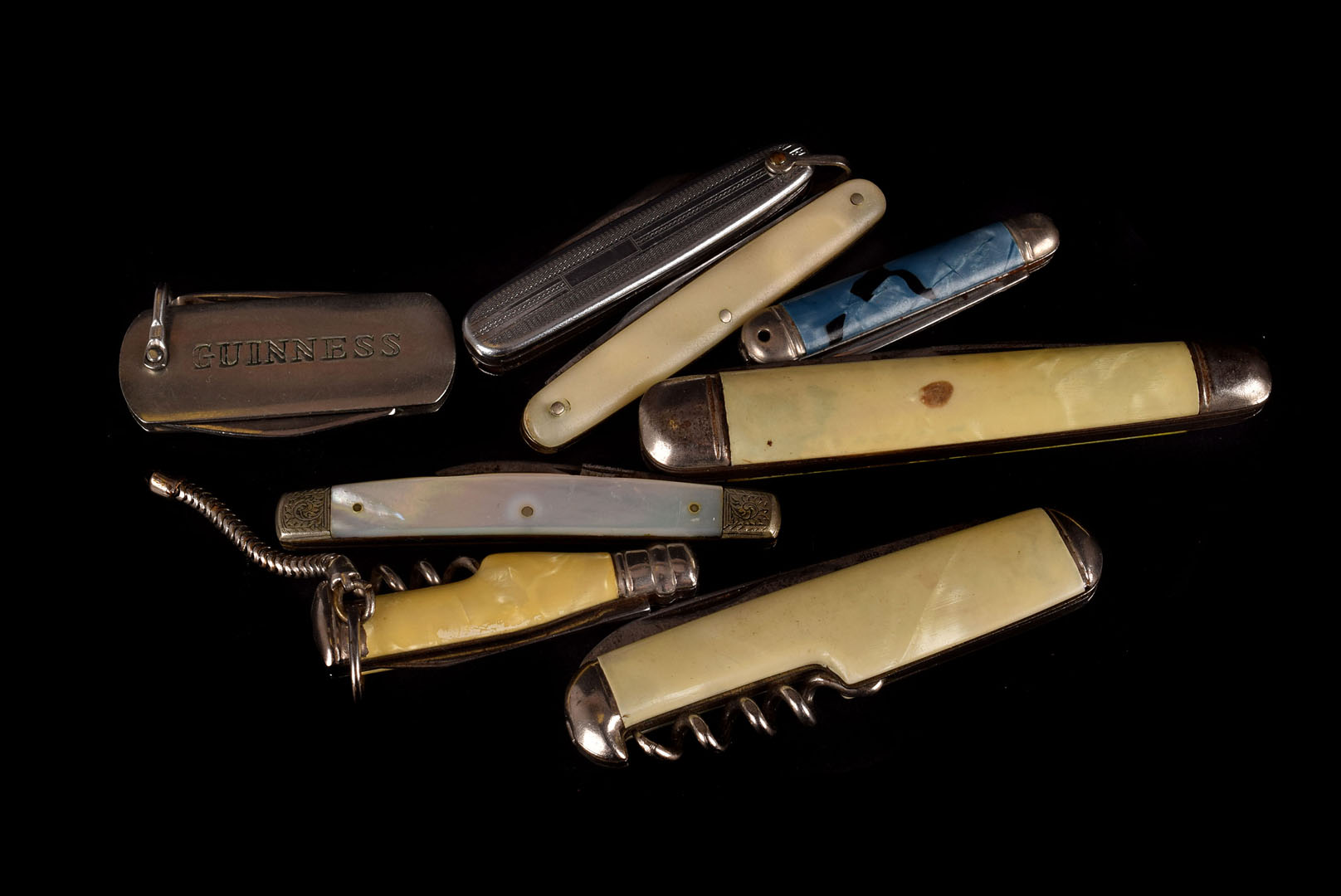 A collection of various penknives, including a silver and mother of pearl example, faux mother of