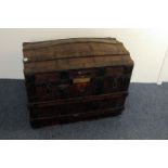 A 19th century wooden travel trunk, with domed lid and wooden and metal strap work, AF