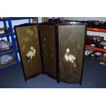 An Edwardian ebonised triple dressing screen, of small proportions and decorated with hand painted