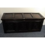 An 18th century and later restored oak and pine coffer, some of the carved panels dated to the