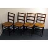 A set of four stained beech kitchen chairs, having rush seats, AF (4)