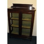 An Edwardian mahogany and inlaid display cabinet, having shelved interior and double doors, with