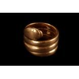 An 18ct gold serpent ring, marked Sheffield, by R.P, the serpent design winding round the finger,