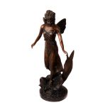 A 1970s bronze figure of a fairy, the large figure in a flowing dress, standing on a flower,