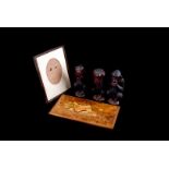 An assortment of various wooden items, including a trio of carved monkeys, photograph frames and