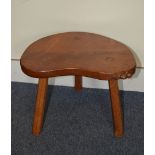 A Beaverman oak stool, having carved beaver to side of the top, on three legs