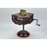 A Kinora three-person Motion Picture Reel Viewer, the ornate mahogany viewer with three adjacent