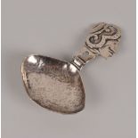 A George V Art Deco silver tea caddy spoon from W.K & Co, having comical head handle and hammered