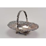 A George III silver bread basket by Robert Gainsford, Sheffield 1822, with heavily chased and