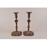 A pair of George II silver candlesticks by John Perry, London 1756, with knopped twist stem over