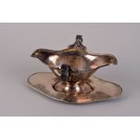 A George V silver twin handled sauce boat by Daniel Arter, Birmingham 1916, plus associated