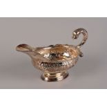 A George II/III style silver sauce boat from Milne & Campbell, with serpentine edge and rococo