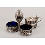 A four piece Edwardian silver cruet set from William Hutton, comprising two trench salts, pepper and