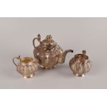 An Indian white metal melon shaped tea set, with cobra handles, probably Lucknow though unmarked,